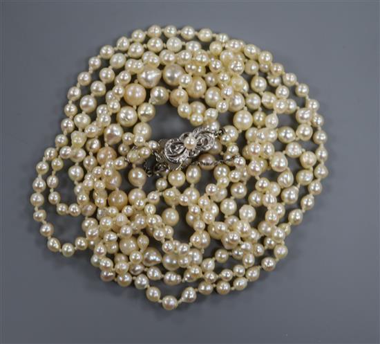 A long single strand graduated cultured pearl necklace, with 14ct white gold Mikimoto clasp, 162cm.